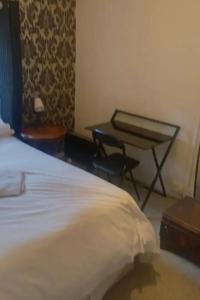 a bedroom with a bed and a table in it at Townhouse Wexford in Wexford