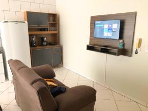a living room with a couch and a flat screen tv at Lindo Apto102 em Primavera do Leste in Primavera do Leste +26 photos