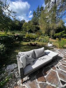 a white couch sitting on a stone patio at Green House bei Baden 