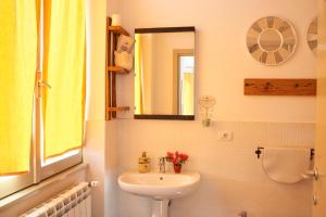 a bathroom with a sink and a mirror at Jerry & Titty house in Capena +49 photos