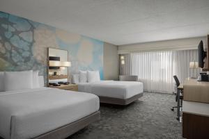 a hotel room with two beds and a desk at Courtyard Indianapolis Northwest in Indianapolis +28 photos