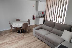 a living room with a couch and a table at Azorina House in Ponta Delgada