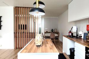 a kitchen with a table and a dining room at Azorina House in Ponta Delgada
