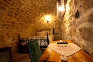 a room with a table and a bed in a cave at ASTARTE HOTEL in Urfa