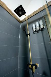 a shower with four lights on the wall of a bathroom at ASTARTE HOTEL in Urfa