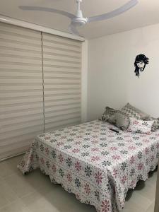 a bedroom with a bed with a blanket on it at Ricaurte-Girardot Casa Condominio Bahia Solero in Ricaurte