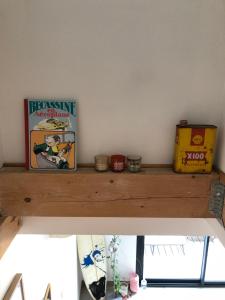 a wooden shelf with a book and other items on it at La Casa Del Racou in Argelès-sur-Mer