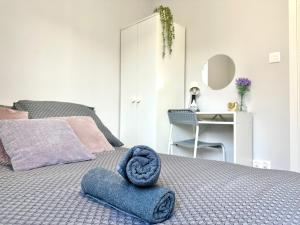 a bedroom with a bed with a blue towel on it at MMRent Pink Fusion Room in Gdańsk