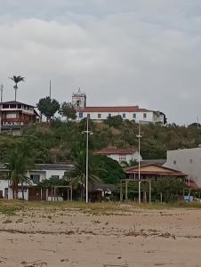 a group of buildings on a hill next to a beach at Sunny Beach in Serra