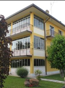 a yellow building with balconies on it at Villa Sartori in Legnago