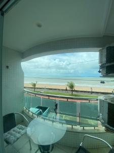 a bathroom with a sink and a view of a beach at Flat Manaíra Palace in João Pessoa