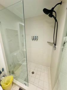 a bathroom with a shower with a glass door at Beachwalk Resort & Condos in Hallandale Beach