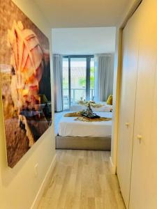 a bedroom with a bed and a painting on the wall at Beachwalk Resort & Condos in Hallandale Beach