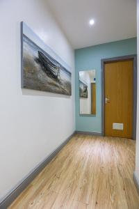 a room with a door and a painting on a wall at A101 Comfy Stylish Loft in Coventry