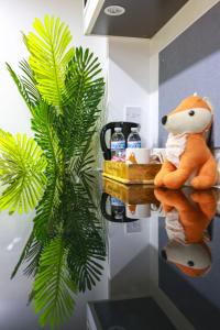 a stuffed animal sitting on a shelf next to a plant at A101 Comfy Stylish Loft in Coventry