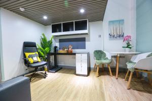 a room with a desk and two chairs and a table at A101 Comfy Stylish Loft in Coventry