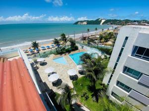 a view of the beach from the balcony of a resort at Apart-Hotel Beira Mar de Ponta Negra - Harmony Suítes in Natal