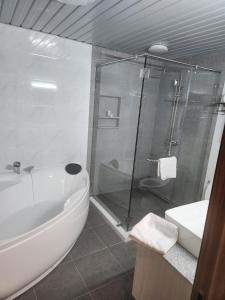 y baño con ducha, bañera y lavamanos. en La Grande Residence 10th Floor Deluxe Unit, en Ángeles
