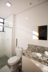 a bathroom with a toilet and a sink at Locking Lourdes in Belo Horizonte