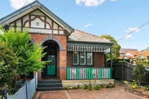 a red brick house with a green door at EDW19 - Stylish 2-Bed, 2-Bath Townhose in Drummoyne in Sydney