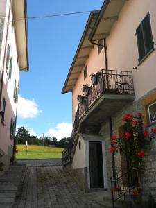 Elle offre une vue sur l'extérieur d'un bâtiment doté d'un balcon. dans l'établissement La Castagna Matta, à Albareto