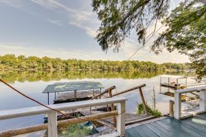 een dok met twee boten op een meer bij Waterfront Jonesville Studio on Black River Lake! 