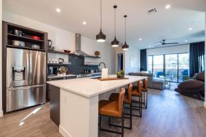 a kitchen with a large island with bar stools at Residence 1- The Villas At Troon North Golf Club townhouse in Scottsdale