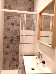 a bathroom with a sink and a shower at Maria Surfista_ As Três Marias in Matosinhos