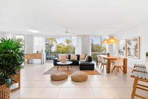 a living room with a couch and a table at Penthouse with Private Roof top terrace- NOOSA in Noosa Heads