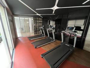 a group of treadmills in a gym with treadleys at Locking's Lourdes 13 in Belo Horizonte