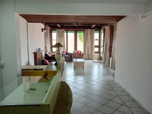 a living room with a couch and a table at Pousada Kanaxuê in Barra Velha