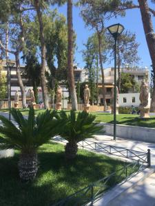 a park with palm trees and a lamp post at maison paisible 80 m2 in Athens