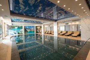 a house with a swimming pool in the middle of it at Grand Elegant & SPA in Kopaonik