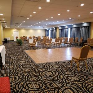 a room with chairs and tables and a large room with a ballroom at Red Roof Inn Atlanta Airport NE Conley in Conley