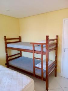 2 Etagenbetten in einem Zimmer mit einem Bett in der Unterkunft Quadra da praia Ar-condicionado in São Vicente