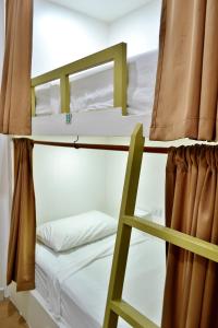 two bunk beds in a room with a ladder at Hotel Petén Express in Flores +40 photos