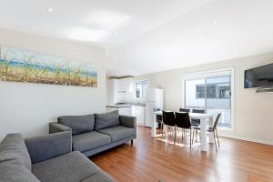 a living room with a couch and a table at Portland Holiday Village in Portland