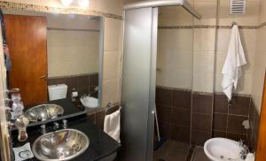a bathroom with two sinks and a mirror at Supercéntrico la Docta in Cordoba +16 photos