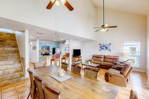 a living room with a table and a couch at Ladyfish Landing in Padre Island
