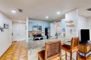 a kitchen with blue cabinets and a counter top at Ladyfish Landing in Padre Island