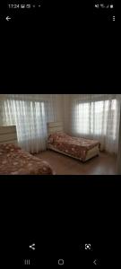 two pictures of a bedroom with two beds at Luxry apartment in Abdoun. Amman, jordan in Amman
