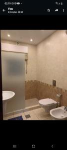 a bathroom with two sinks and a toilet at Luxry apartment in Abdoun. Amman, jordan in Amman