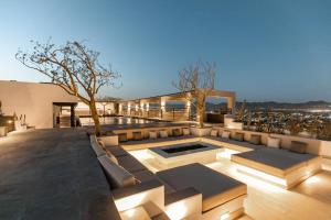 a rooftop patio with a view of the city at Lumina at Cardinal Cabo San Lucas in Cabo San Lucas