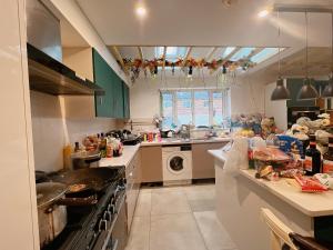 a kitchen with a sink and a washing machine at Detached house a room B in Essex in Waltham Abbey
