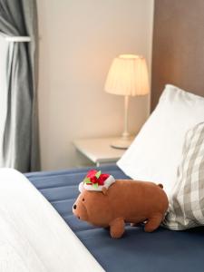 a stuffed animal is sitting on a bed at Contemporary Comfort Sleek Studio Casa De Parco in Samporo