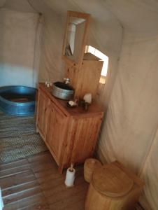 a bathroom with a toilet and a tub in a yurt at Saba Berber Travel in Mhamid