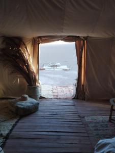 a tent with a view of the ocean from the inside at Saba Berber Travel in Mhamid