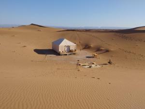 a tent in the middle of a desert at Saba Berber Travel in Mhamid