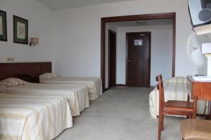 Postel nebo postele na pokoji v ubytování Residencial Greco