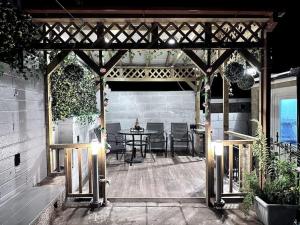 a wooden pergola with a table on a patio at Gorgeous Graceful Getaway w/ Gazebo - Tylorstown in Llwyn-y-pia